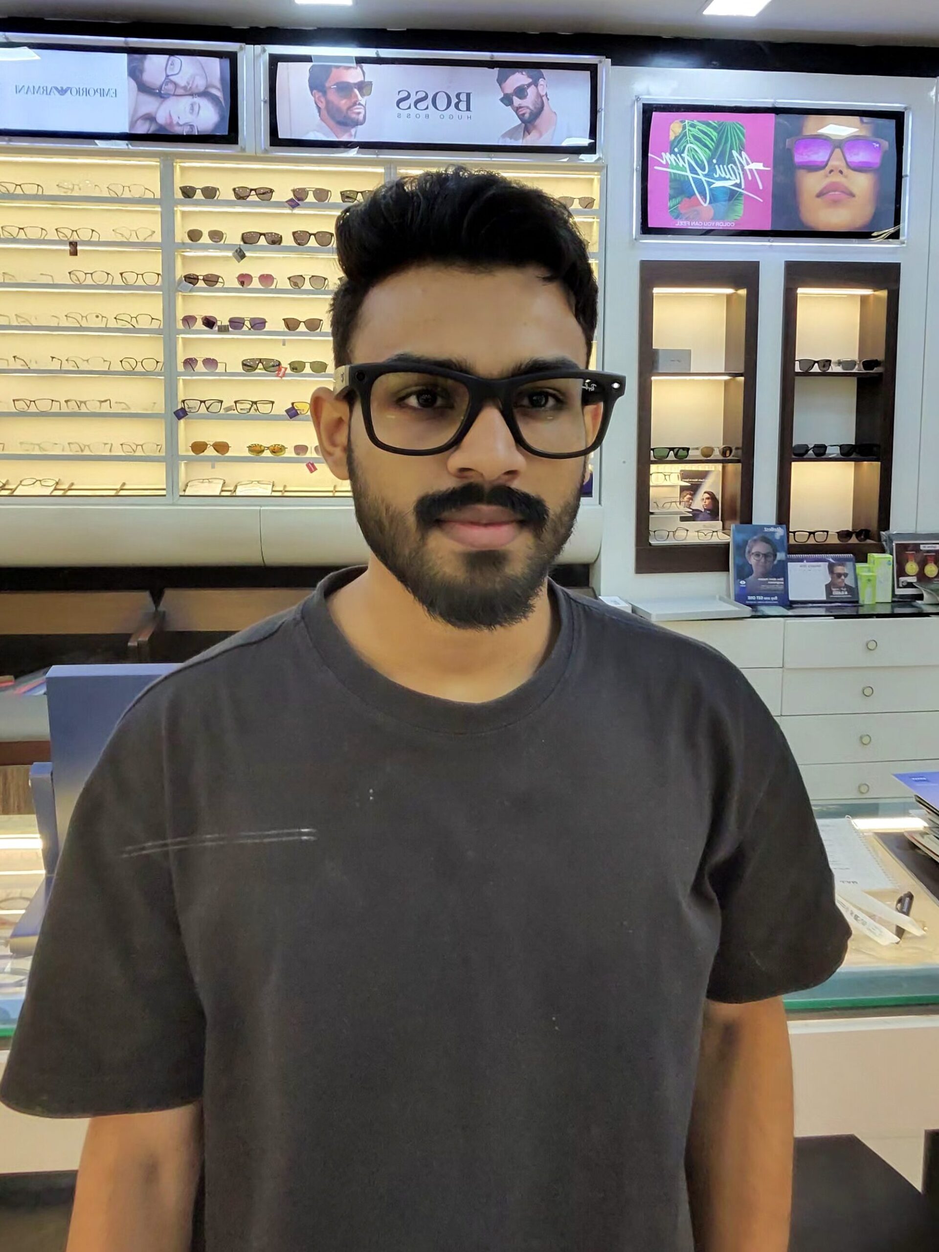 Person wearing Ray-Ban Meta Wayfarer smart glasses in Kannur